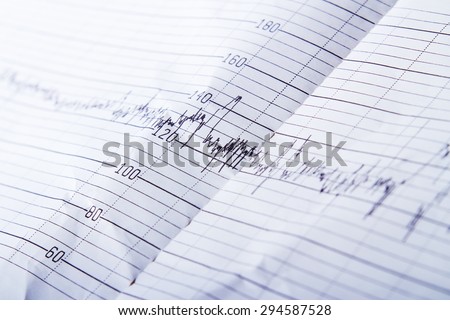 Medical records on paper in the form of peaks closeup.