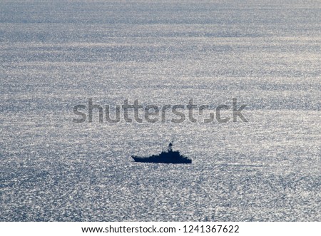 Warship, patrol vessel, coastguard in the Kerch Strait from the Black sea to the Azov sea. Beautiful silvery sea from a bird's-eye view Stock fotó © 