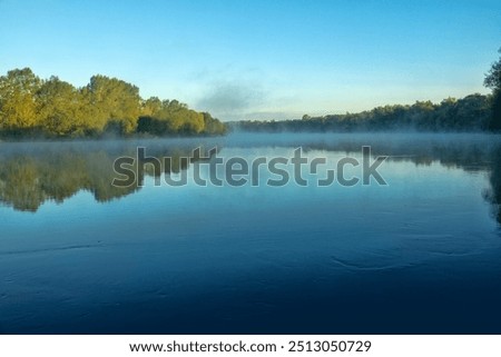 Similar – Image, Stock Photo fog rises over river in dark summer evening. Reeds and water lilies in foreground, bridge in distance. Dull boring sky. Beautiful moody night time