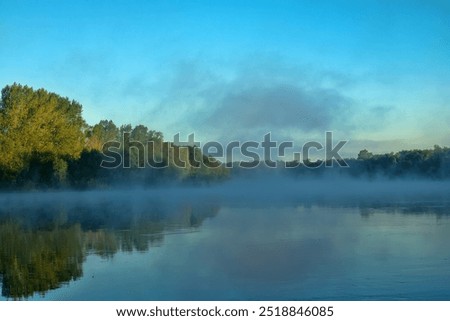 Similar – Image, Stock Photo fog rises over river in dark summer evening. Reeds and water lilies in foreground, bridge in distance. Dull boring sky. Beautiful moody night time