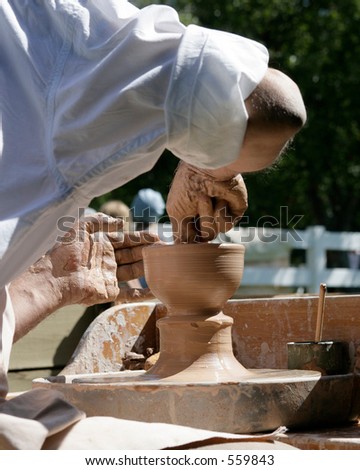 potter making vase on wheel