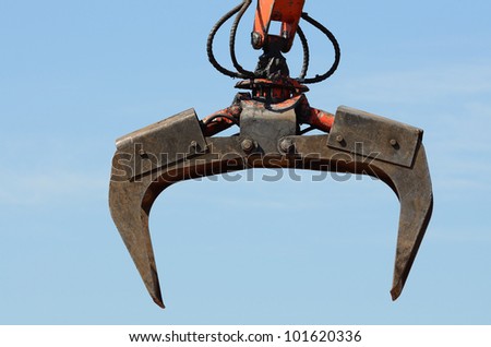 A claw on a compactor moves light weight metal at a recycle yard in Oregon