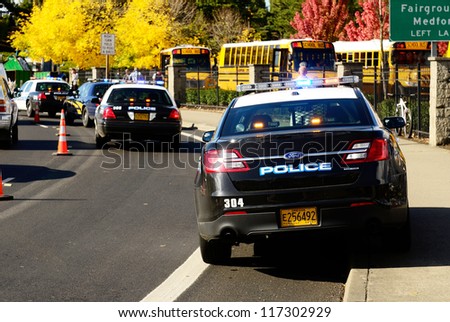 ROSEBURG, OR - OCTOBER 16: Police cars and school buses at an accident at the entrance of the High School loading zone in Roseburg Oregon, October 16, 2012