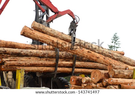 Fir logs being moved for loading onto a commercial ship for export to Asia on the mill dock in Coos Bay and North Bend Oregon