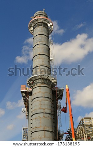 A construction crew installing a new cooling tower on a chemical petroleum oil processing plant in New Orleans