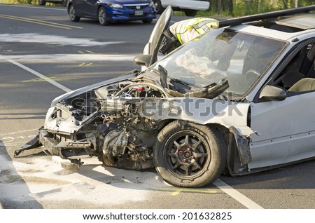 ROSEBURG, OR, USA - MAY 30, 2014: Police and fire fighters survey the scene of a single vehicle accident due to excessive speed sends the driver to the hospital in Roseburg, OR, on May 30, 2014