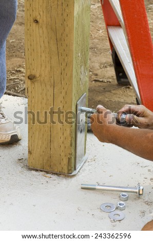 Installing a bolt in a hole to accommodate  a post on a new luxury custom home