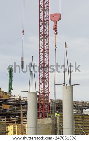 Large tower crane at a modern urban, development construction site  in an concrete and metal project