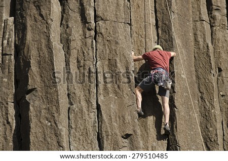 Young man rock climbing at Skinner Butte Climbing Columns. Popular public rock climbing area  in Eugene Oregon.