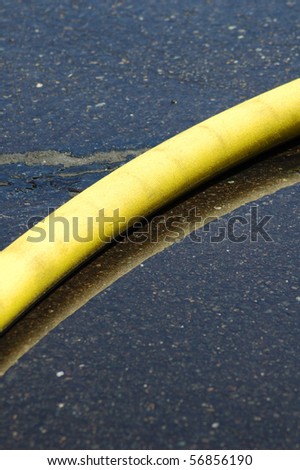 Fire hose on the wet ground during a structure fire.