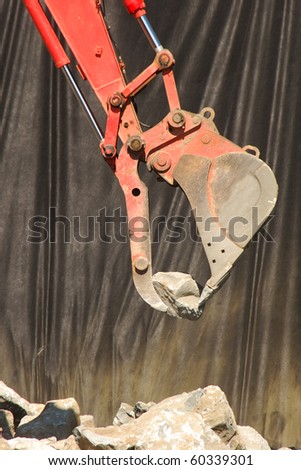 Excavator working on a rip-rap wall to stabilize a cut bank at a new building project in Roseburg OR