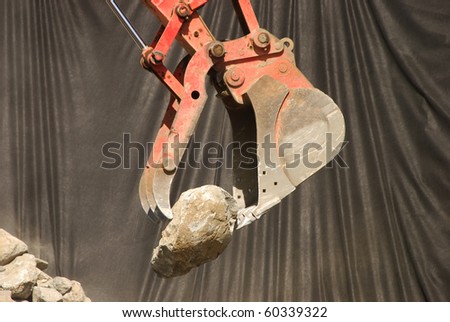Excavator working on a rip-rap wall to stabilize a cut bank at a new building project in Roseburg OR