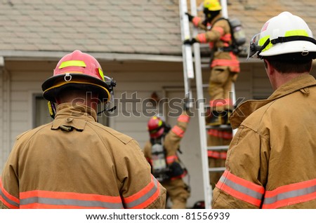 ROSEBURG, OR USA - JULY 21: Roseburg Fire Fighters participating in a vertical ventilation drill at a old hotel in Roseburg, OR USA - July 21, 2011