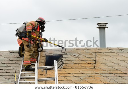 ROSEBURG, OR USA - JULY 21: Roseburg Fire Fighters participating in a vertical ventilation drill at a old hotel in Roseburg, OR USA - July 21, 2011