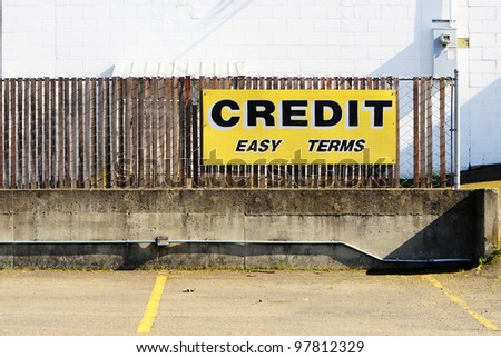 A credit easy terms sign at a now out of business auto sales lot
