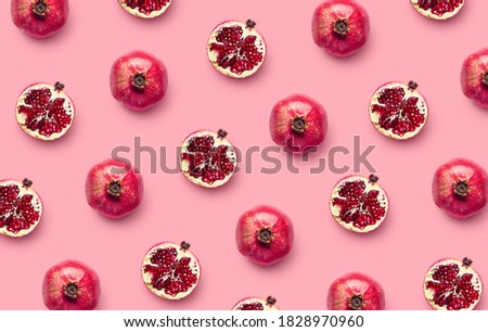 Pattern of fresh pomegranates on pink background, top view, flat lay