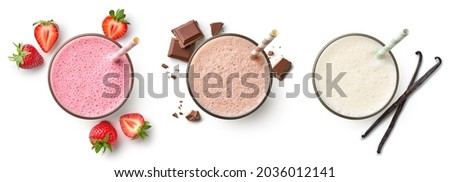 Set of fresh various delicious milkshakes or smoothies, top vies, isolated on white background. Strawberry, vanilla and chocolate flavor Foto stock © 