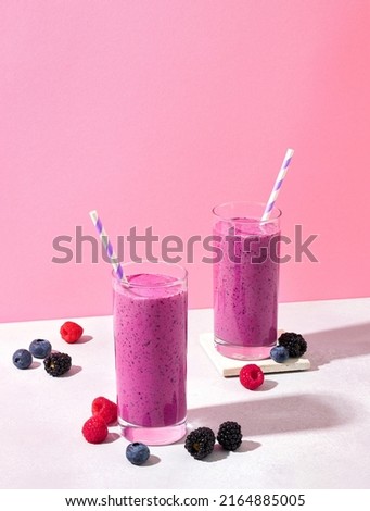 Similar – Image, Stock Photo Strawberry smoothie. Two glasses of berry slush. Summer cold drink