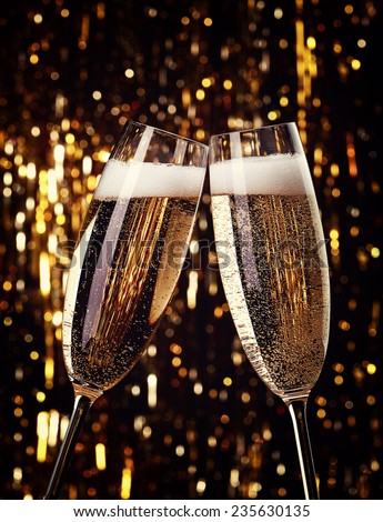Two flutes of champagne on bokeh background