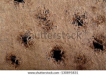 Torn burlap decayed. Ragged linen fabric.