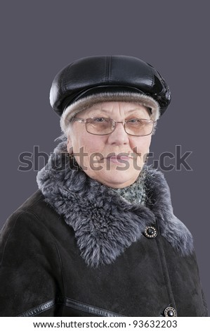 portrait of an elderly woman in winter clothes. isolated