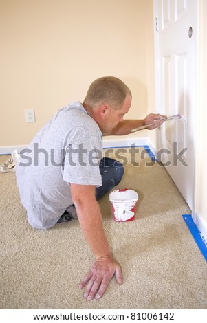 Contract painter updating colors of walls and painting doors,ceilings bright white to speed up selling of home