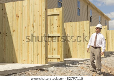 Bank finance personal inspecting new strip mall that his company financed