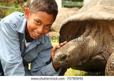 Boy visits Jonathan the tortoise on St Helena. Jonathan the famous giant tortoise who is estimated to be two hundred years old