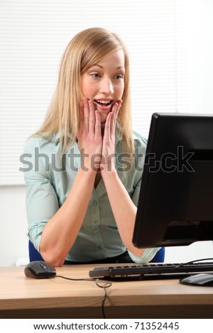 Business woman shocked and surprised by computer
