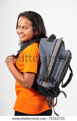 School girl looking over shoulder off to school
