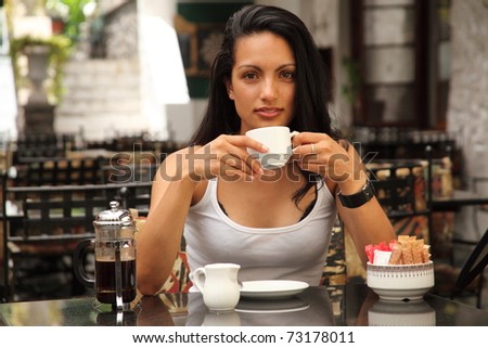 Beautiful girl drinking coffee at cafe