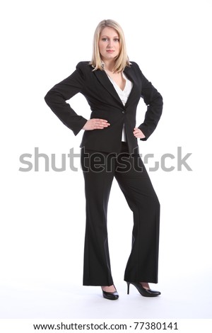 Full body shot of beautiful young blonde business woman, standing with hands on hips. Woman is wearing a black business suit and high heels.