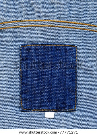 Closeup of blank grungy jeans label on inner side of worn blue denim, kind of a background