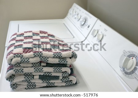 A washer and dryer with folded towels