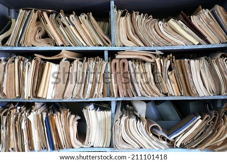 shelves full of files in a messy old-fashioned archive