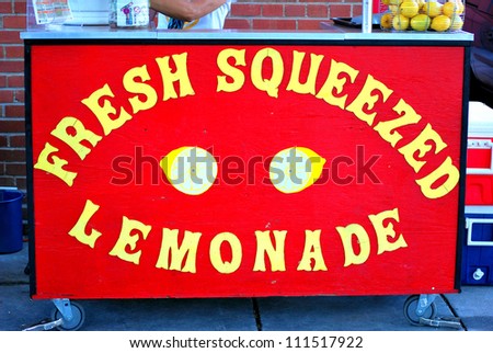Fresh squeezed lemonade stand displayed outdoors.