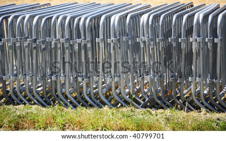 Portable barricade fences stored and ready for use for an outdoor event.