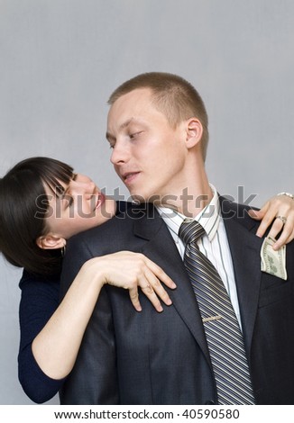 Woman gets money from his jacket pocket men. Picture abstraction.