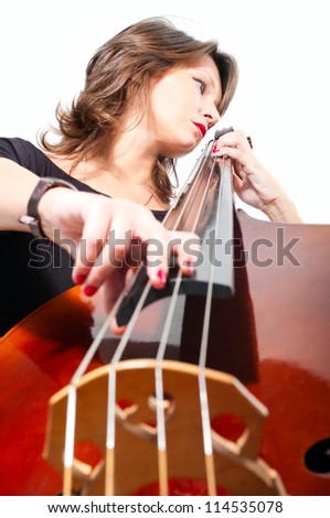 Young woman in black dress play double bass isolated on white. Low point view