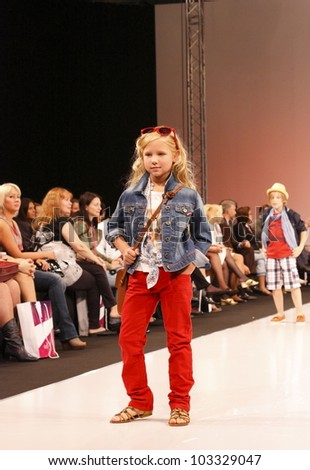 MOSCOW-SEPTEMBER 5:Unidentified child shows a collection of clothes mayoral Spanish company at the international Fashion Fair on September 5, 2011 in Moscow