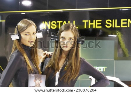 MOSCOW-AUGUST 26: Unidentified models show closers for noiseless door closing company SLAMSTOP at the International Exhibition Automechnika on August 26, 2013 in Moscow
