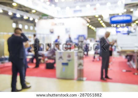 Trade show people, intentionaly blurred background
