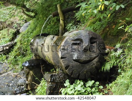 Natural spring water in a fountain in the mountains