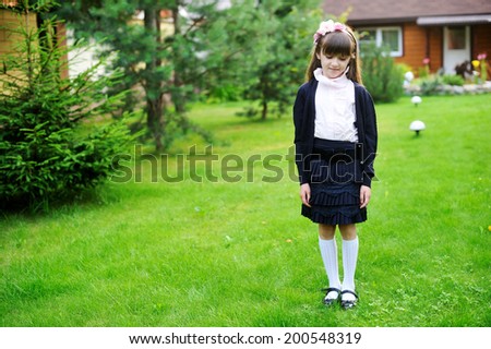 Adorable elegant  kid girl in navy and rose  school uniform having fun outdoors after school