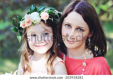 Portrait of beauty mother and  flower girl daughter outdoors on the wedding