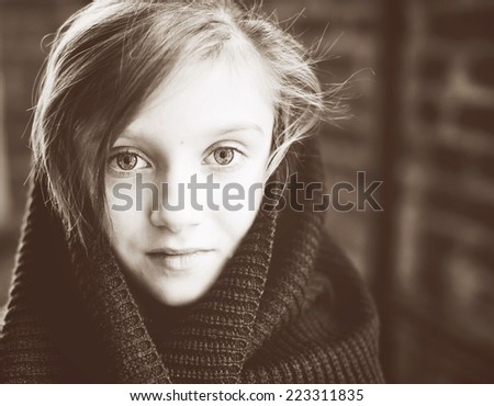 Close-up  retro portrait of brunette child girl, in knitted snood sepia tone added
