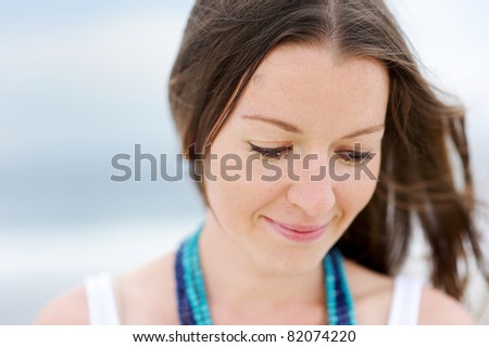Portrait of a beautiful brunette woman looking down
