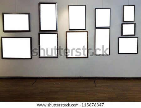 Empty photo frames on gallery wall