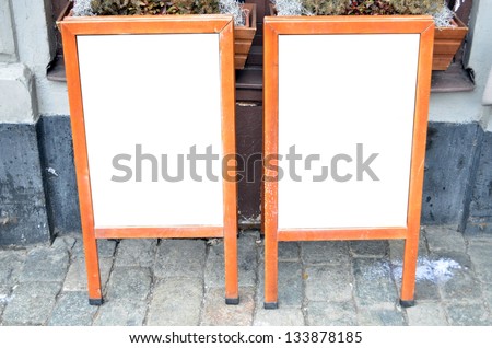 Pair of empty menu boards at street