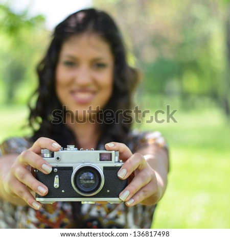 Portrait of woman holding vintage camera - Focus on camera (retro style)
